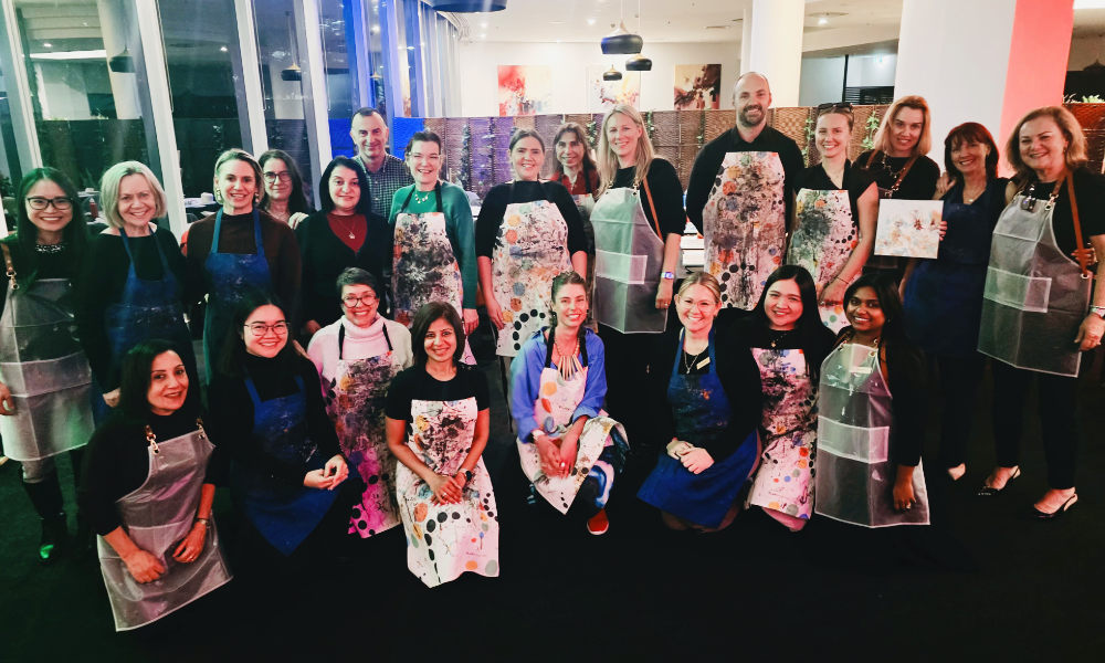 The full group of VIP guests with their finished artworks after the Crowne Plaza workshop