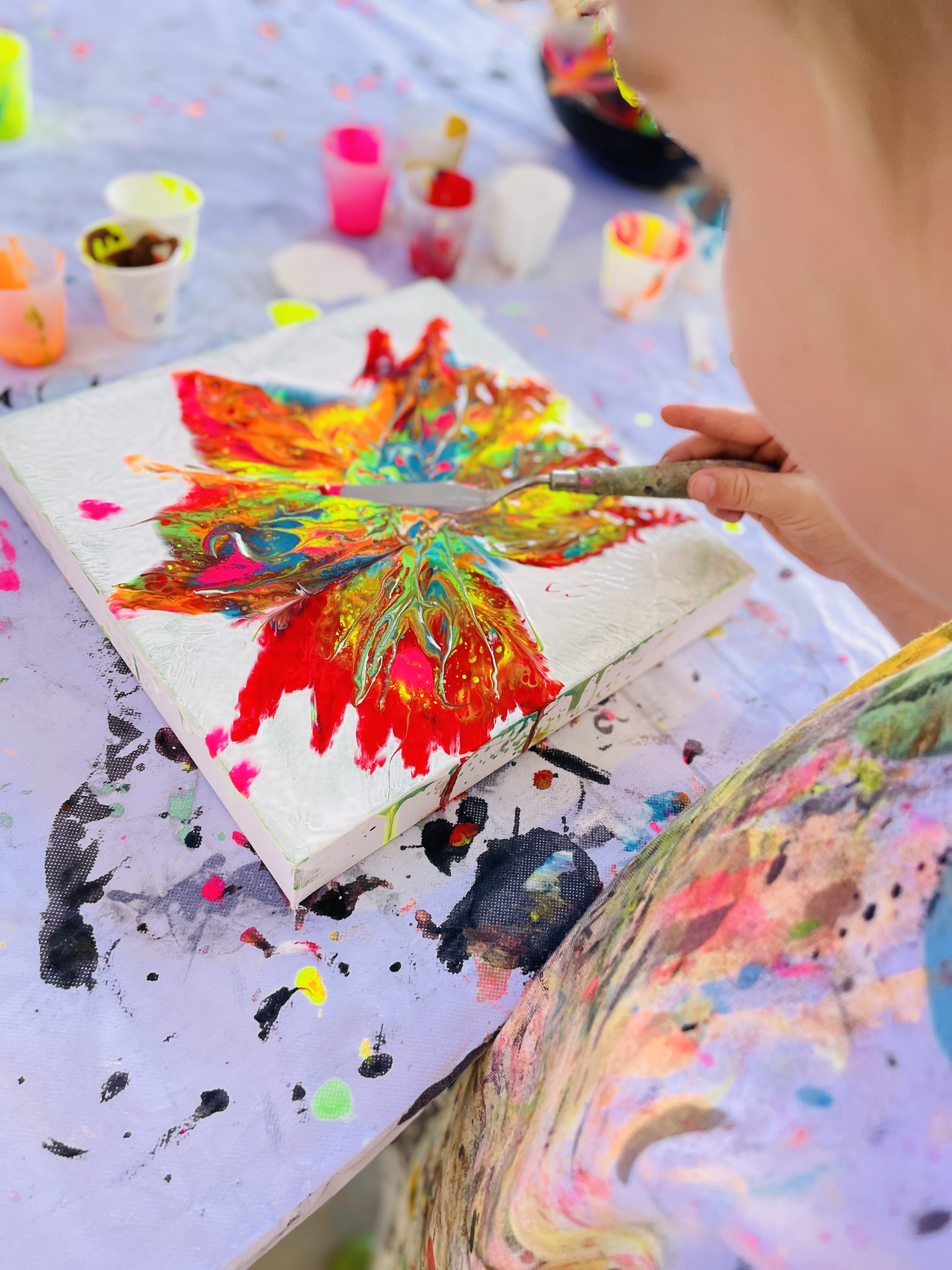 Kids exploring fluid art with unusual tools